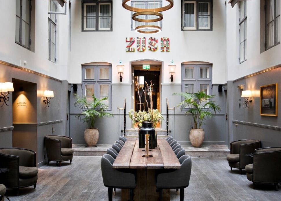 Chic atrium at Hotel SKT. Annæ, København, Denmark, DK, featuring modern seating and lush decor.