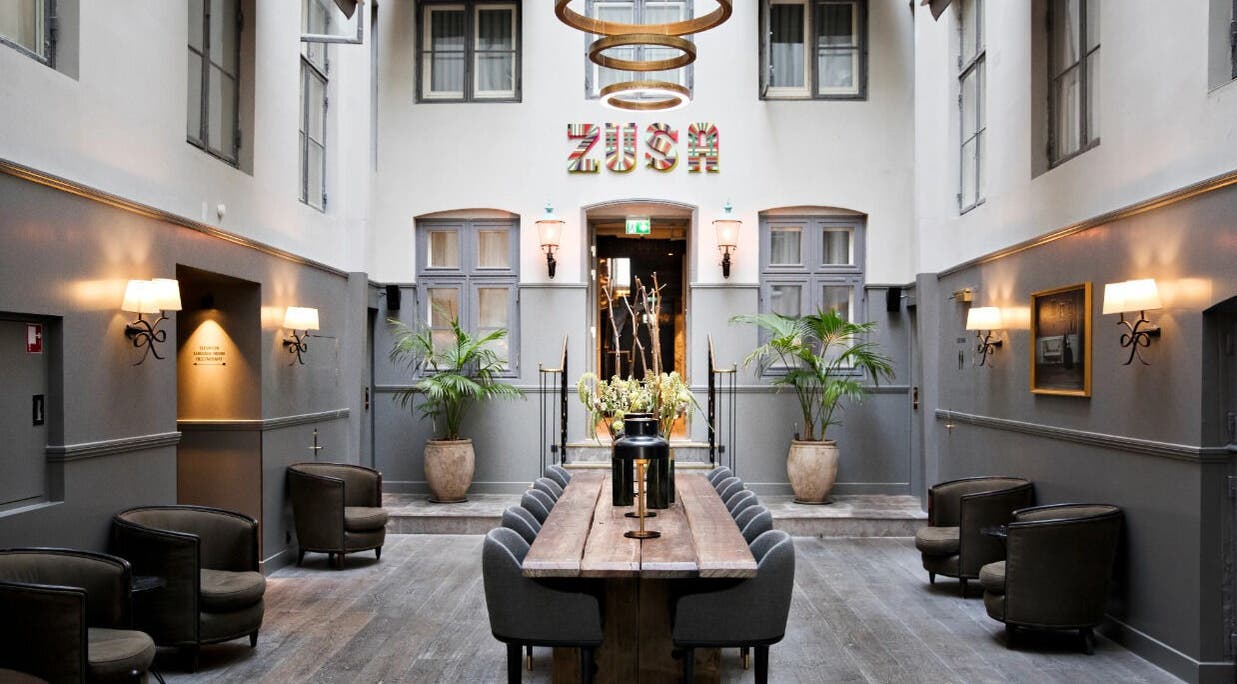 Chic atrium at Hotel SKT. Annæ, København, Denmark, DK, featuring modern seating and lush decor.