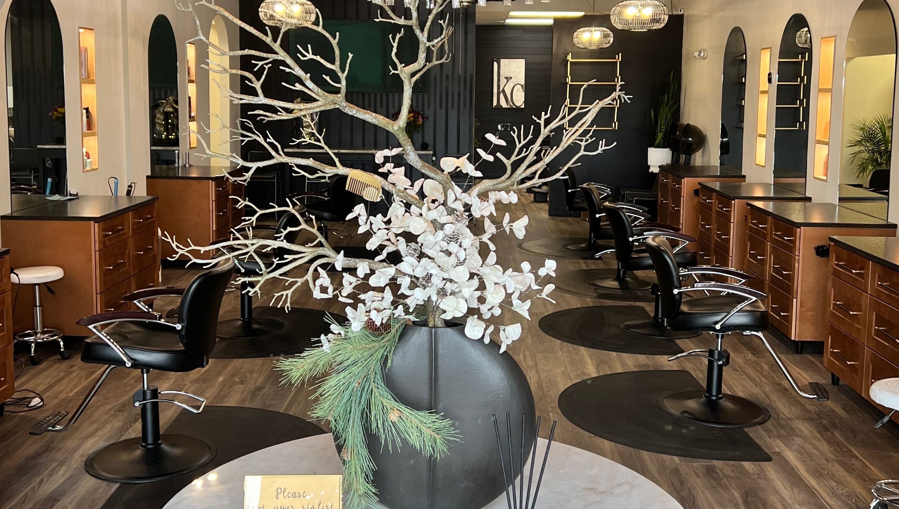 Elegant interior of Angie's Hair Salon Studio in Overland Park, Kansas, US showcasing modern styling chairs and decor.