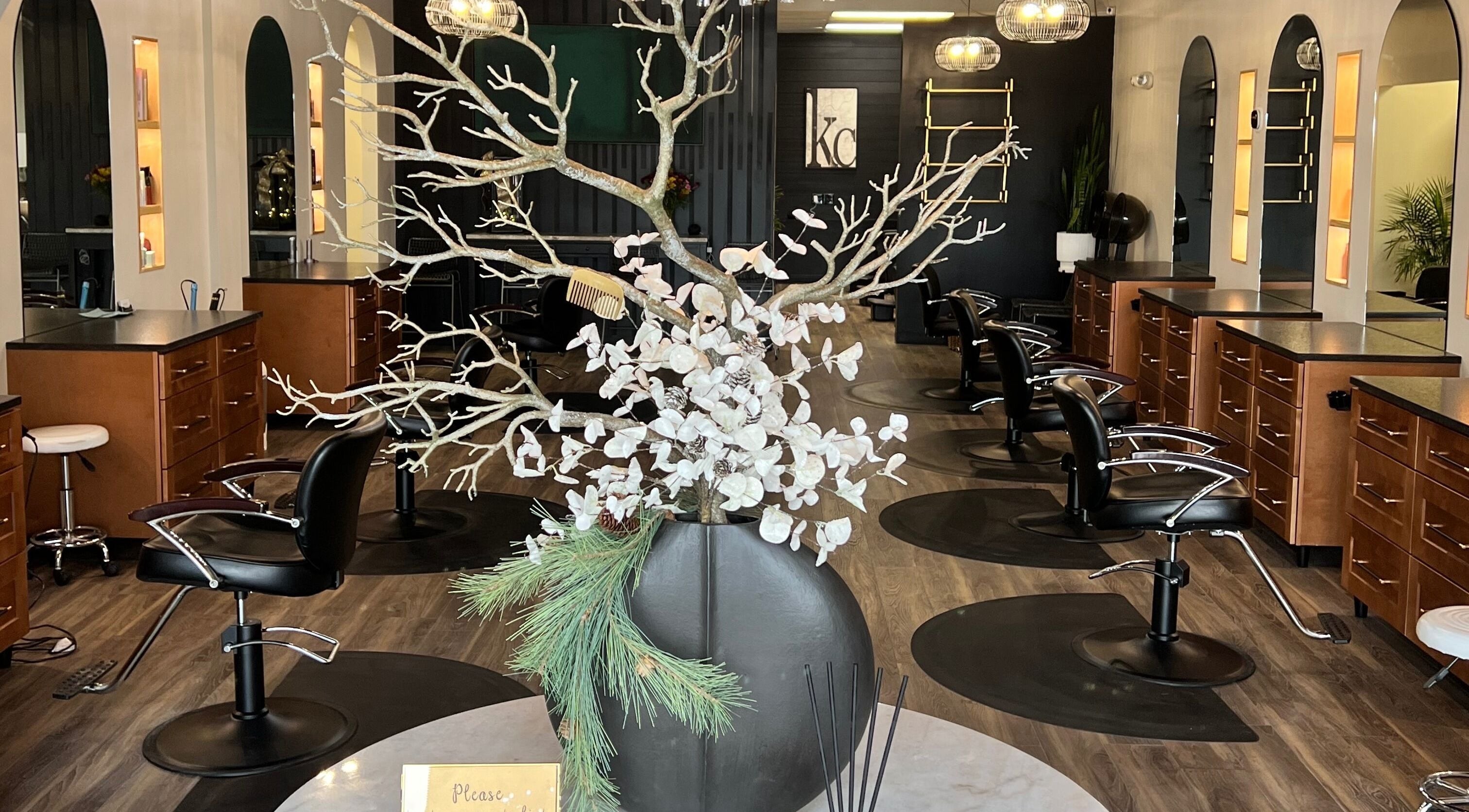 Elegant interior of Angie's Hair Salon Studio in Overland Park, Kansas, US showcasing modern styling chairs and decor.