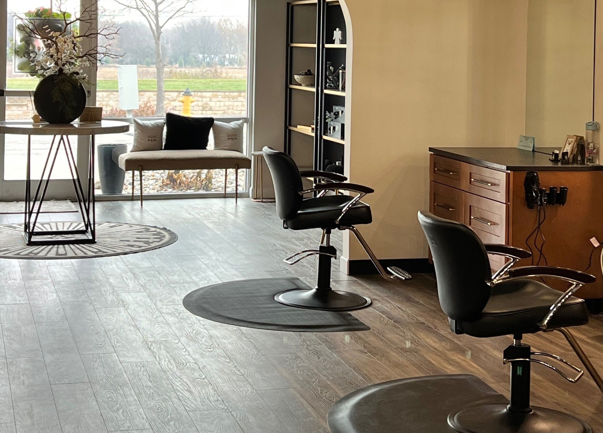 Sleek interior of Angie's Hair Salon Studio, Overland Park, Kansas, US showcasing modern styling chairs and decor.