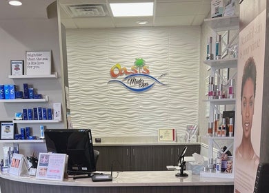 Reception desk at Oasis Med Spa in Venice, Florida, US showcasing skincare products and welcoming ambiance.