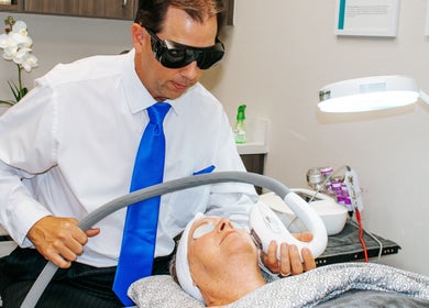 Technician performing laser treatment at Oasis Med Spa in Venice, Florida, US. Professional skincare service.