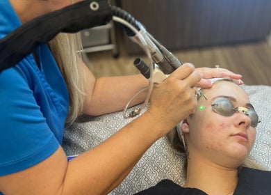 Client receives laser facial treatment at Oasis Med Spa, Venice, Florida, US for glowing skin.