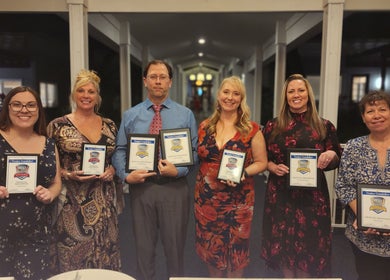 Award ceremony at Oasis Med Spa, Venice, Florida, US, featuring smiling team members with plaques.