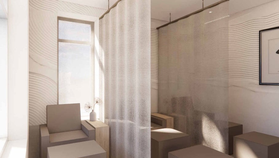 Tranquil seating area at Lux Beauty Bar • Hair Spa in Grimsby, Ontario, CA, with soft curtains and modern decor.