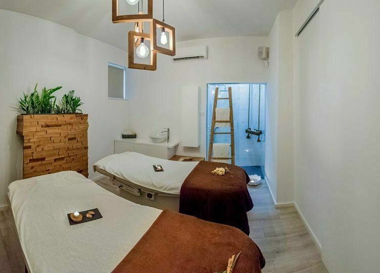 Tranquil treatment room at Suenso Spa, Limassol, Limassol, CY featuring two massage tables and serene decor.