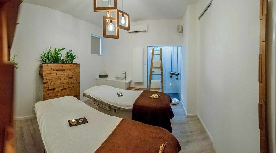 Tranquil treatment room at Suenso Spa, Limassol, Limassol, CY featuring two massage tables and serene decor.