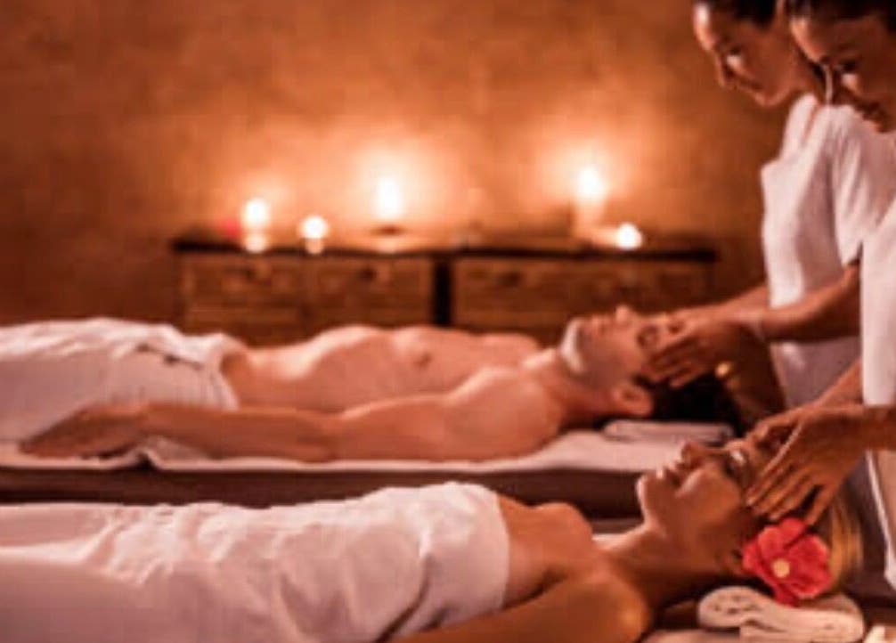 Relaxing couple's massage at Fern Spa & Massage in Auckland, Auckland, NZ with dim lighting and soothing ambiance.