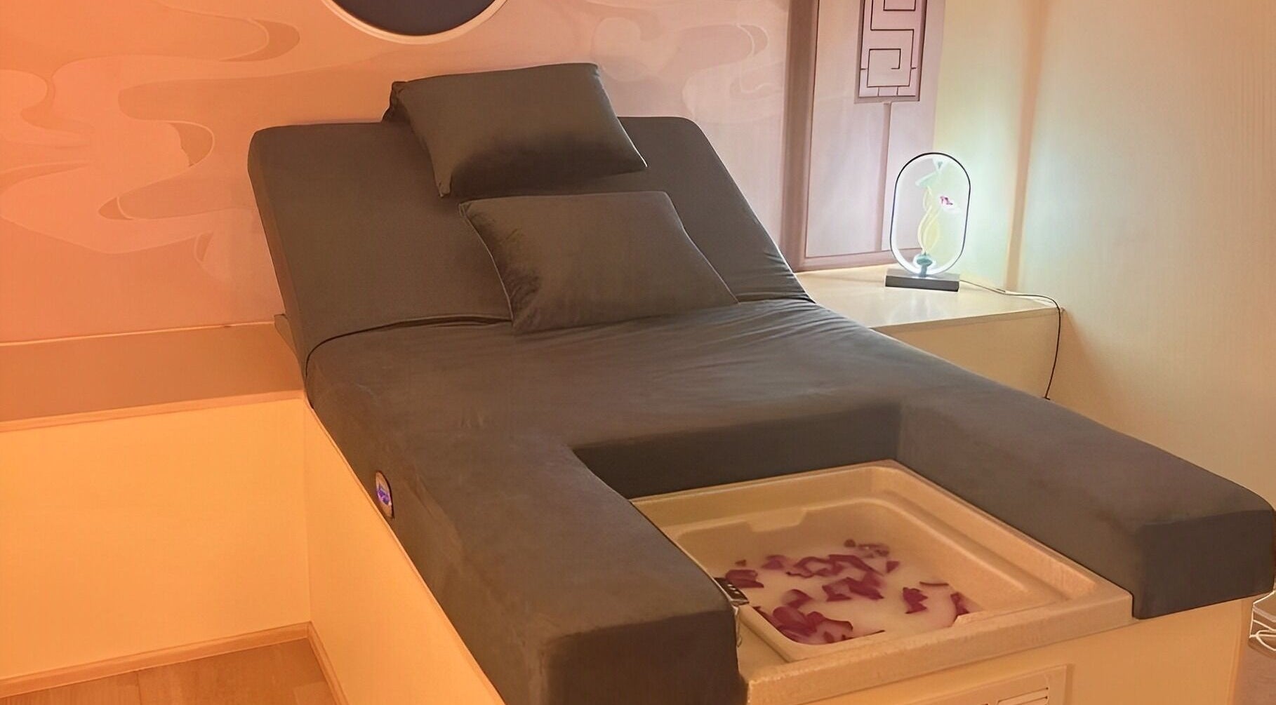 Luxurious massage chair at FR Foot Spa in Sheffield, Ohio, US with ambient lighting and cozy pillows.