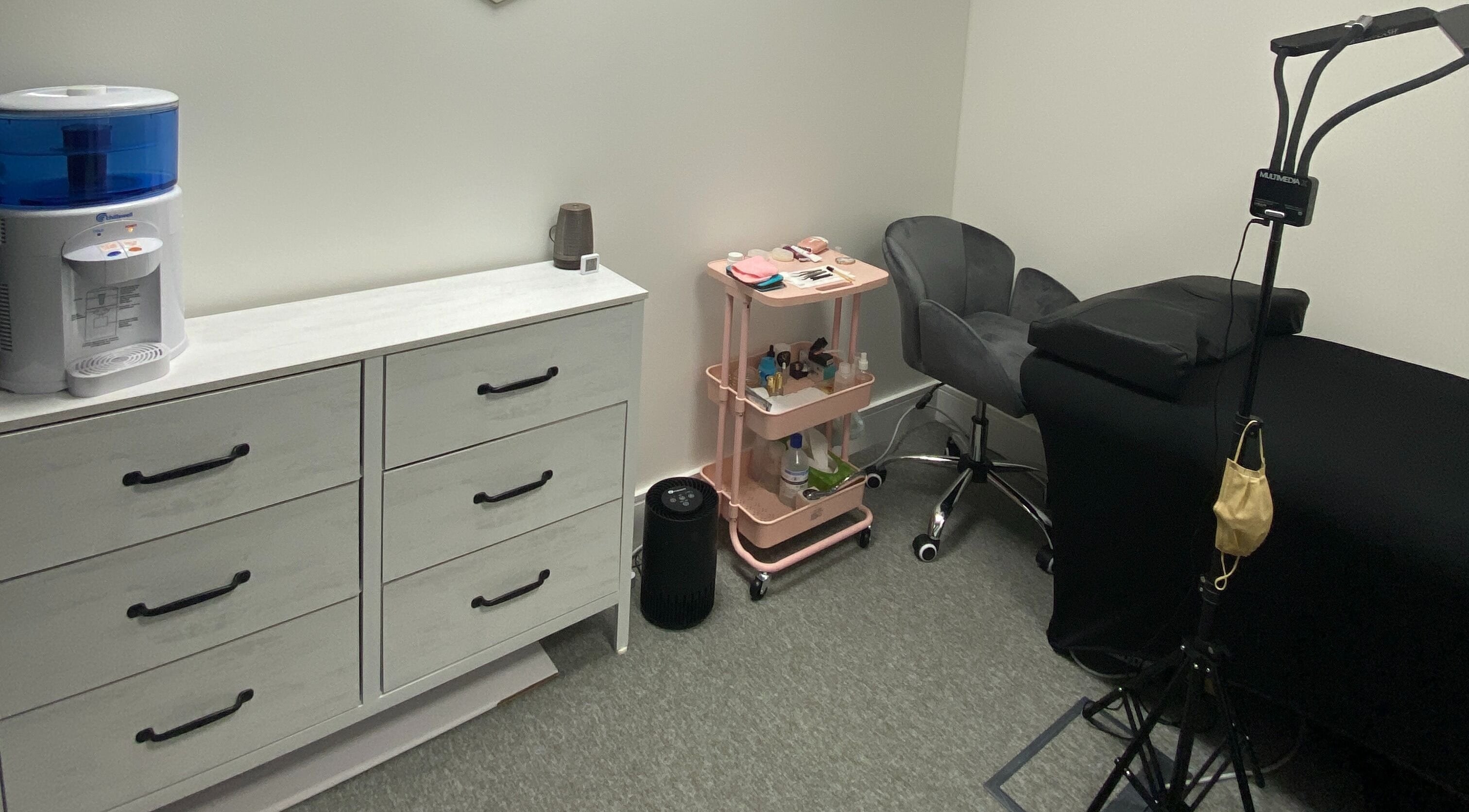 Cozy treatment room at Blink PN Lash in London, England, GB, featuring a comfortable chair and organized supplies.