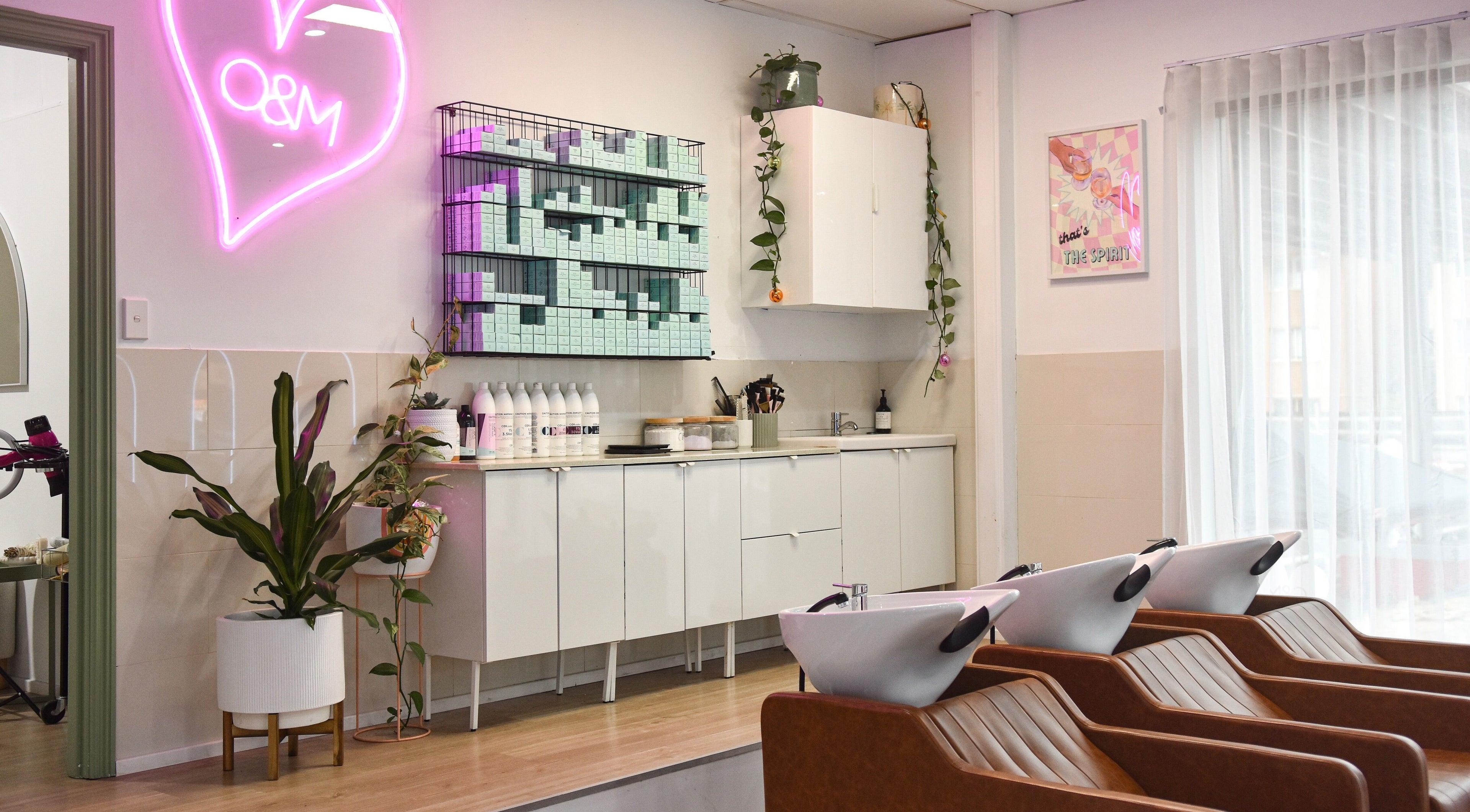 Stylish interior of Young & Co The Salon in East Gosford, NSW, featuring washing stations and vibrant decor.