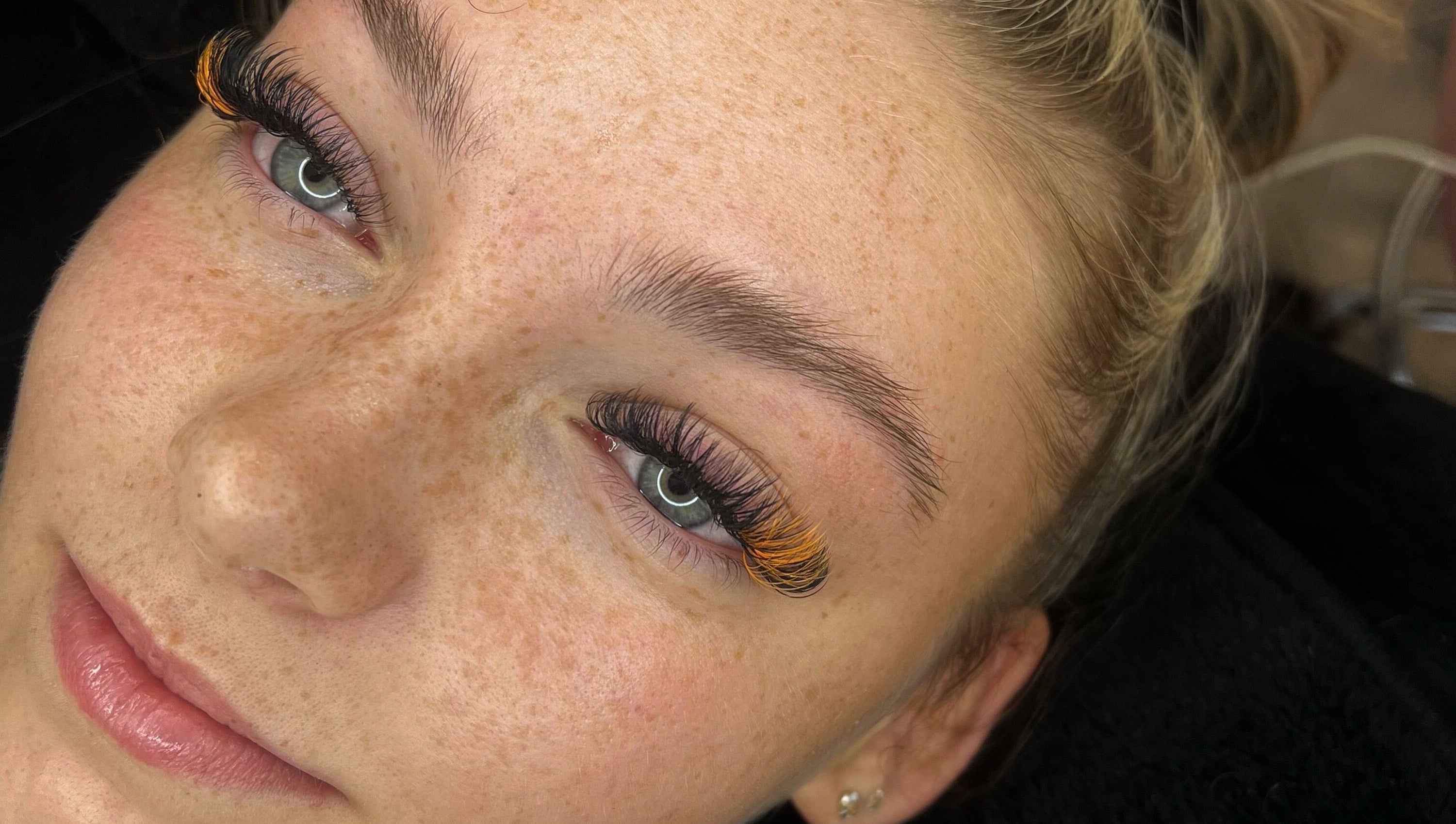 Close-up of a woman with vibrant eyelash design at Enhanced by Hope, South Croydon, England, GB.