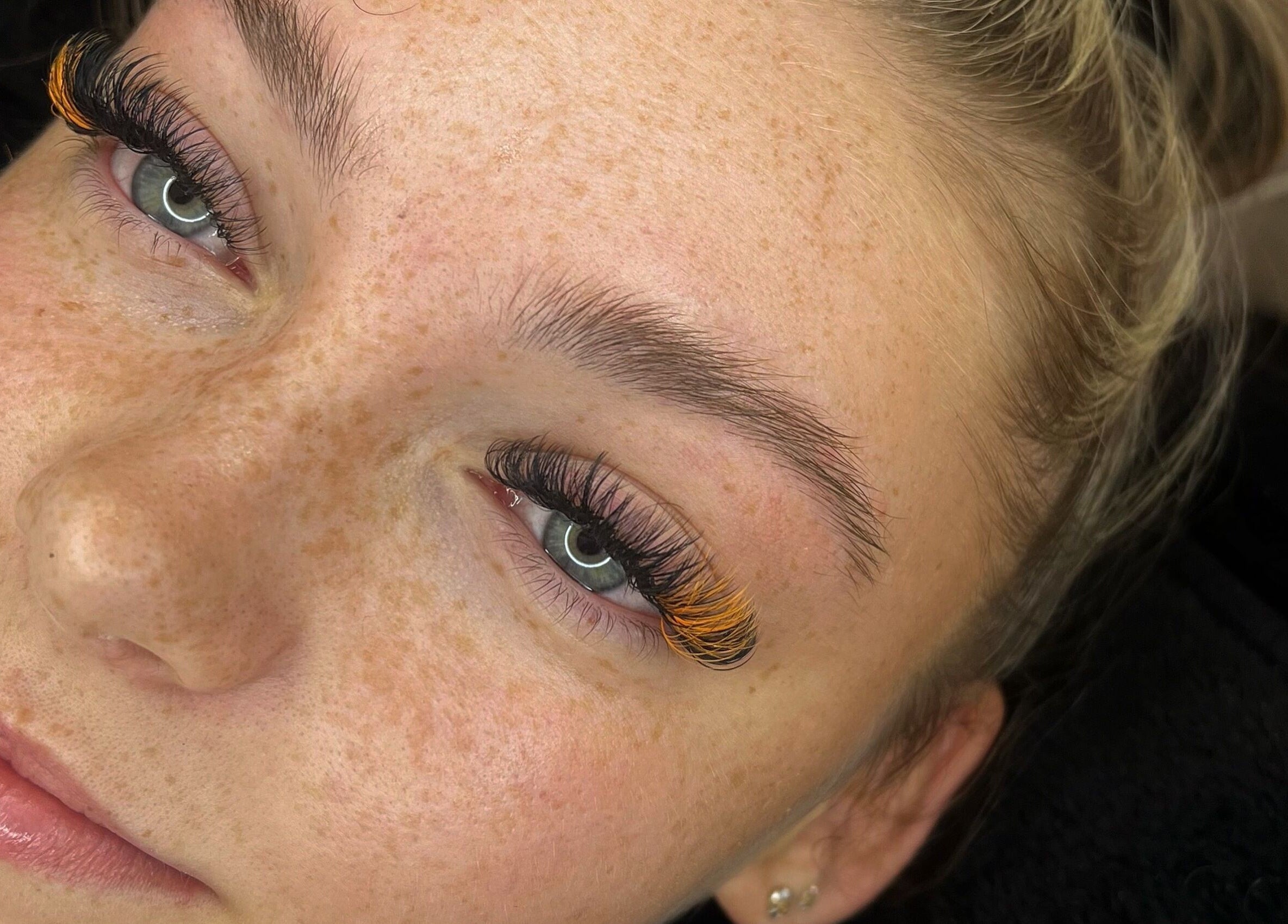 Close-up of a woman with vibrant eyelash design at Enhanced by Hope, South Croydon, England, GB.