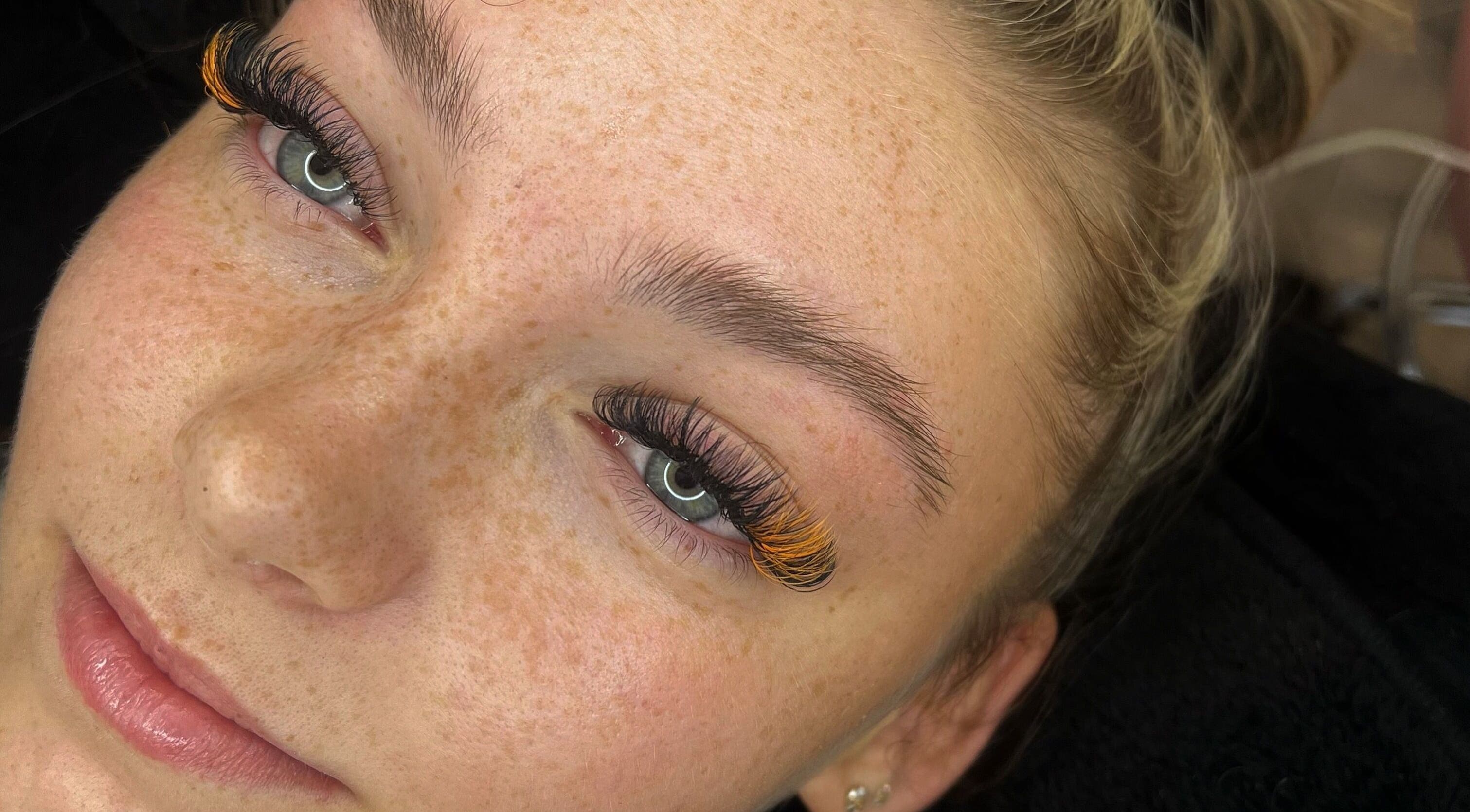 Close-up of a woman with vibrant eyelash design at Enhanced by Hope, South Croydon, England, GB.