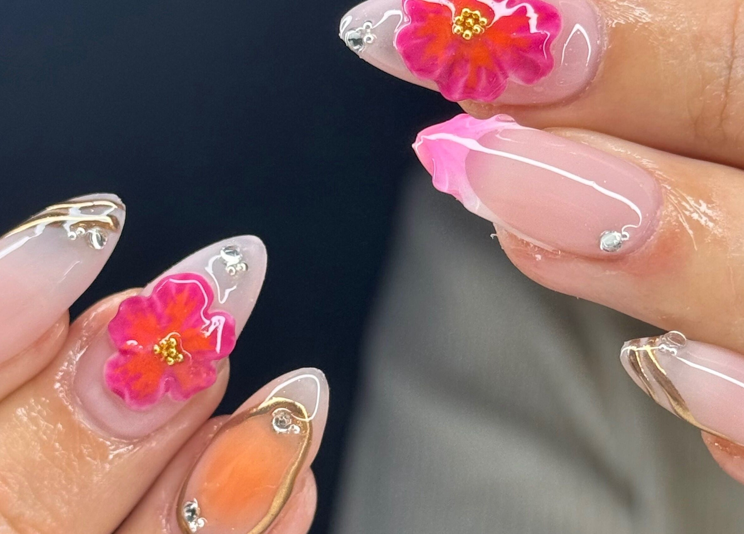 Intricate floral nail art at Montè Beauty, Melbourne, Victoria, AU, showcasing vibrant colors and delicate designs.