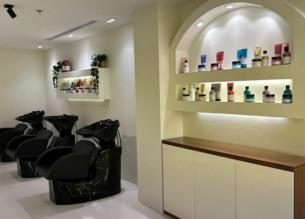 Noor Beauty Salon in Dammam, Eastern Province, SA featuring modern washing stations and sleek product display.