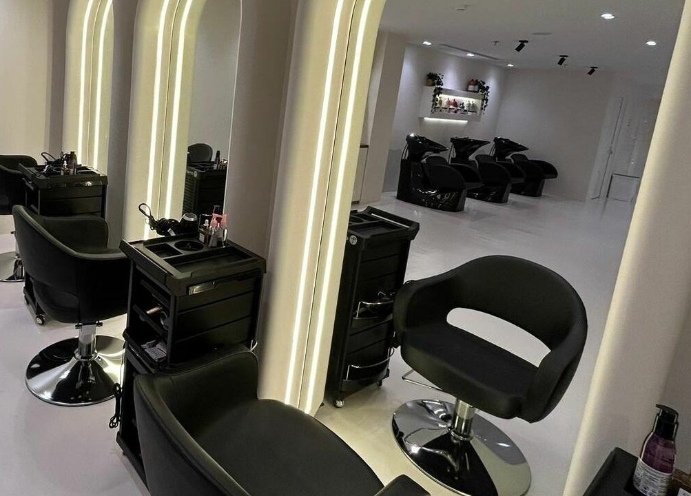 Elegant interior of Noor Beauty Salon in Dammam, Eastern Province, SA, featuring modern styling chairs and mirrors.