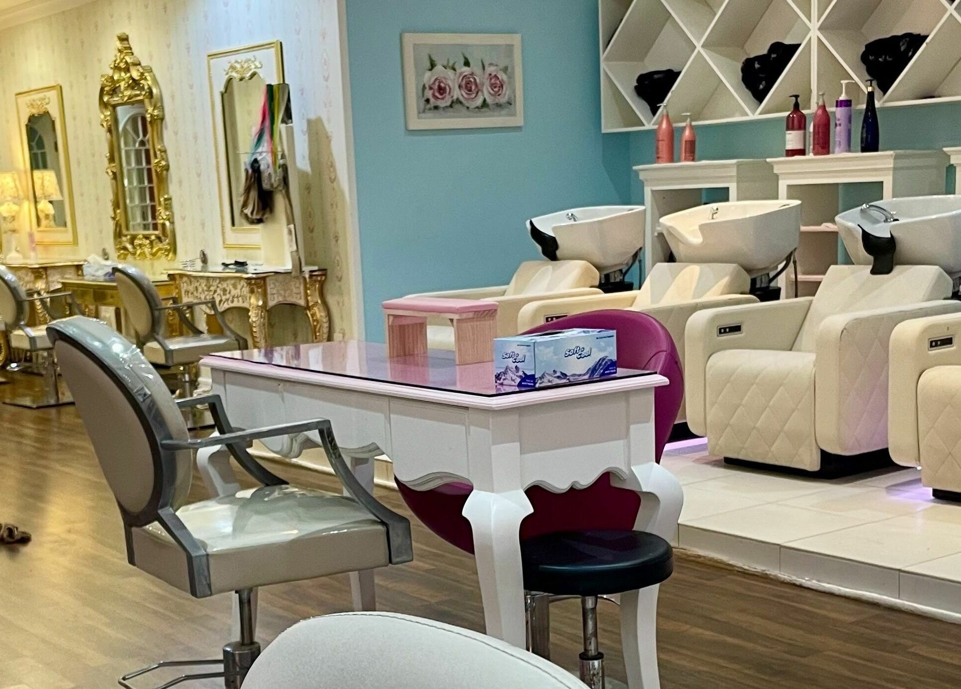 Luxurious interior of Pout Salon and Spa in Dubai, AE with ornate gold mirrors and plush salon chairs.