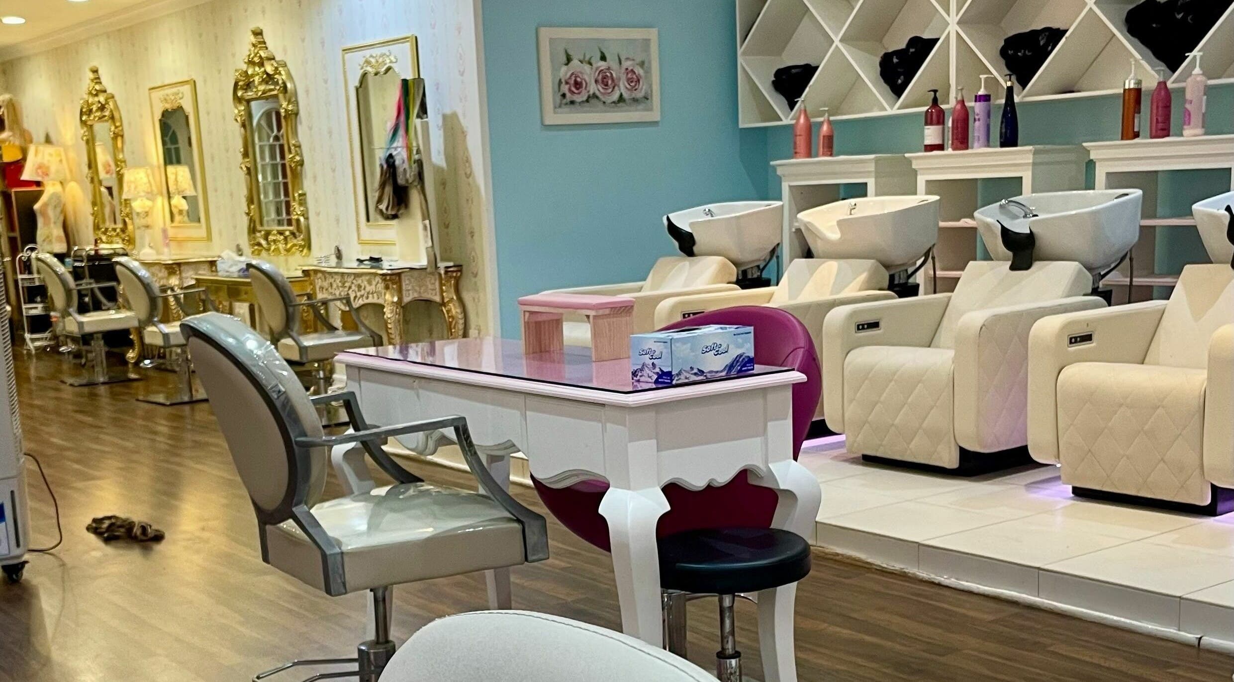 Luxurious interior of Pout Salon and Spa in Dubai, AE with ornate gold mirrors and plush salon chairs.