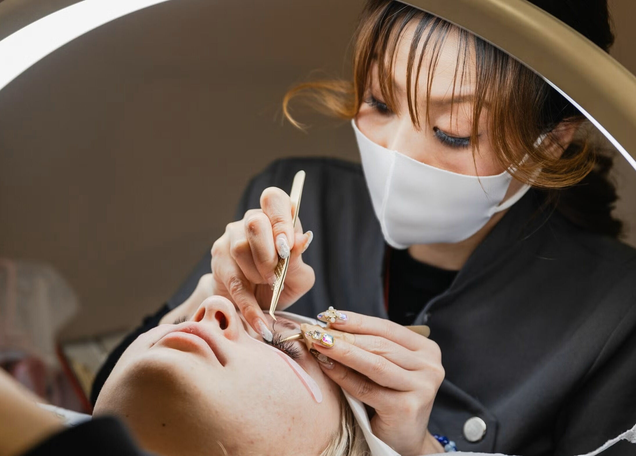 Technician applying eyelash extensions at Lash and Brow Avenue - Liverpool, New South Wales, AU.