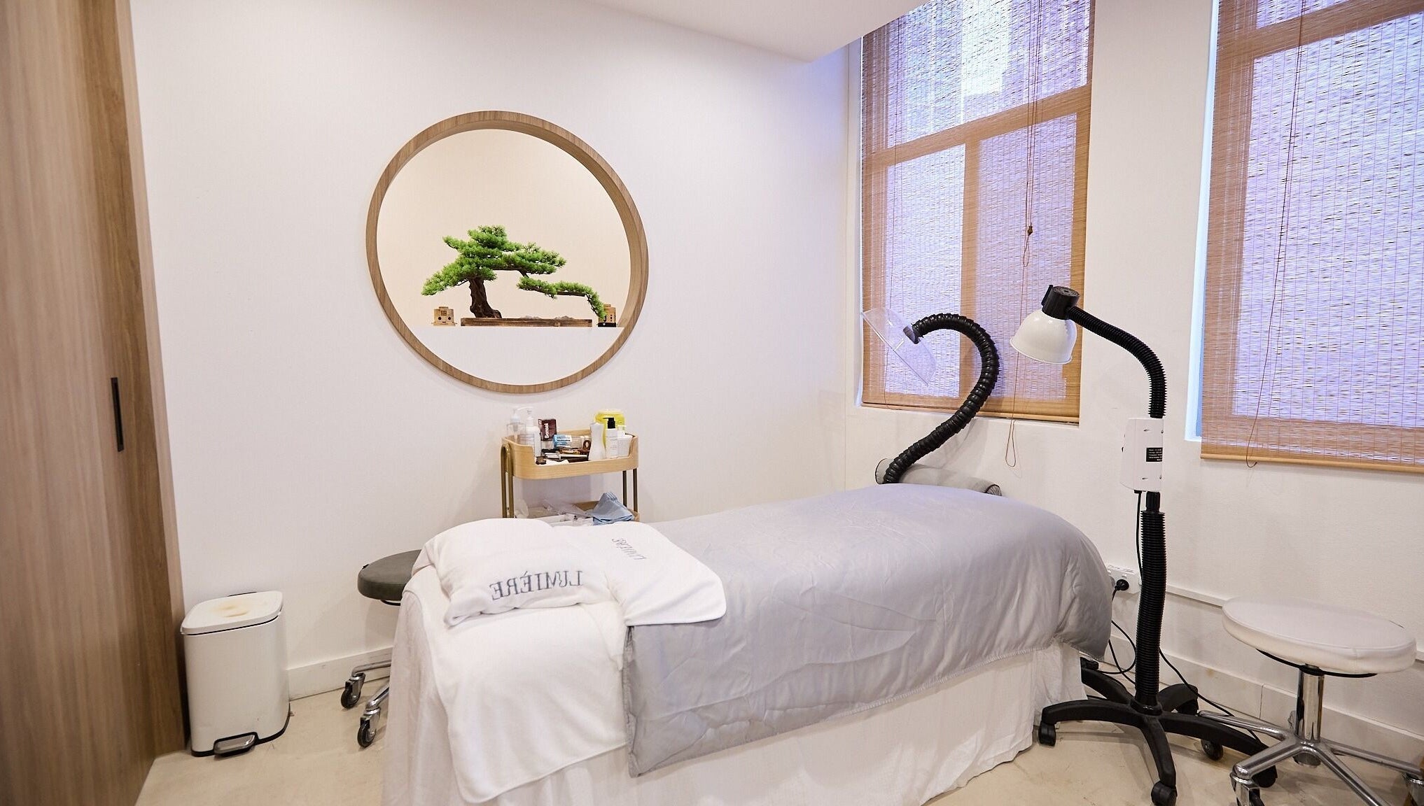 Calming treatment room at Lumiere Spa and Wellness, Haymarket, New South Wales, AU with massage bed and decor.