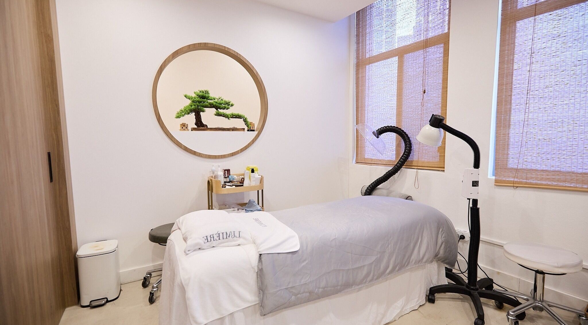 Calming treatment room at Lumiere Spa and Wellness, Haymarket, New South Wales, AU with massage bed and decor.