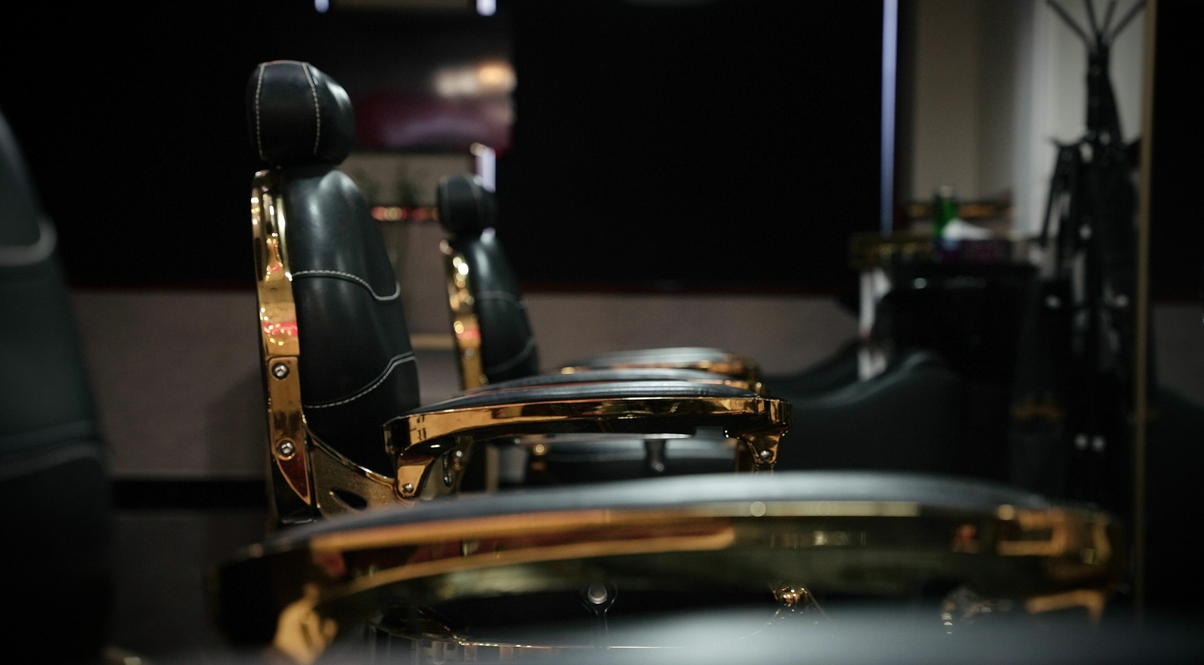 Luxurious barber chairs at The Sharp Edge Gents Salon, Dubai, AE, showcasing elegance and comfort.