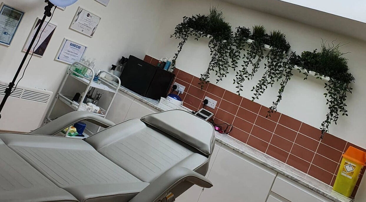 Modern treatment room at AnneMarie Beauty Enhanced, Johnston, Wales, GB with comfortable chair and serene decor.