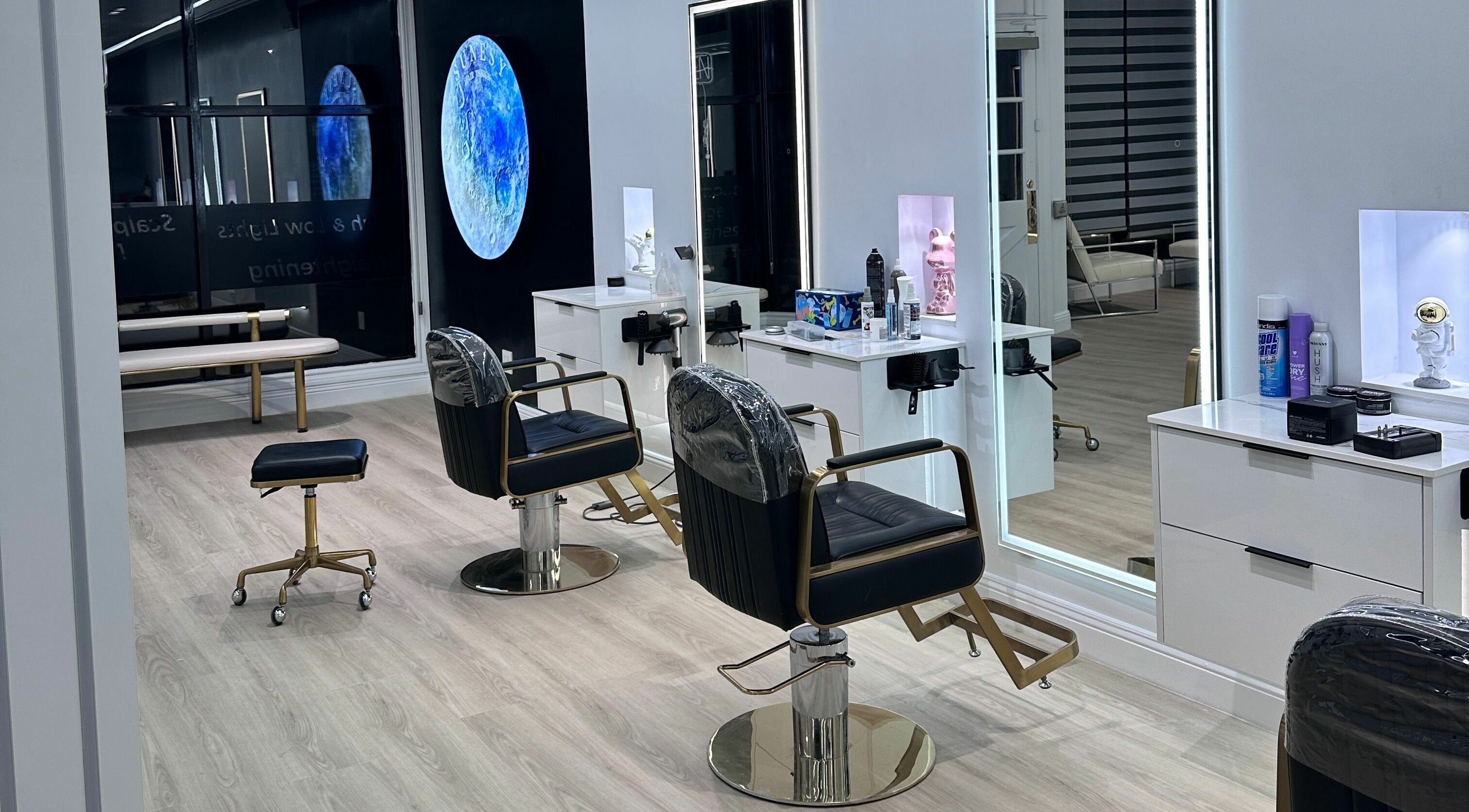 Sleek interior of Sunesy Hair Salon in San Mateo, California, US showcasing styling chairs and mirrors.