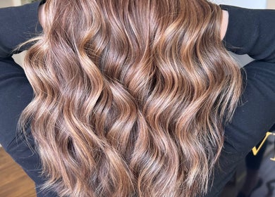Lustrous wavy hair styled at Valori Hair, Melbourne, Victoria, AU, showcasing expert color and texture.