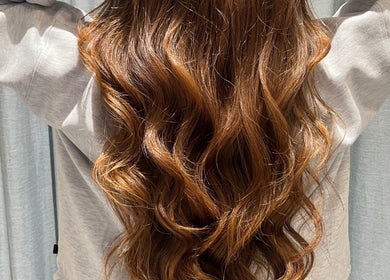 Lustrous wavy hair styled at Valori Hair, Melbourne, Victoria, AU, showcasing vibrant color and shine.