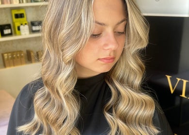 Elegant blonde waves hairstyle at Valori Hair, Melbourne, Victoria, AU. Showcasing salon's expertise in styling.