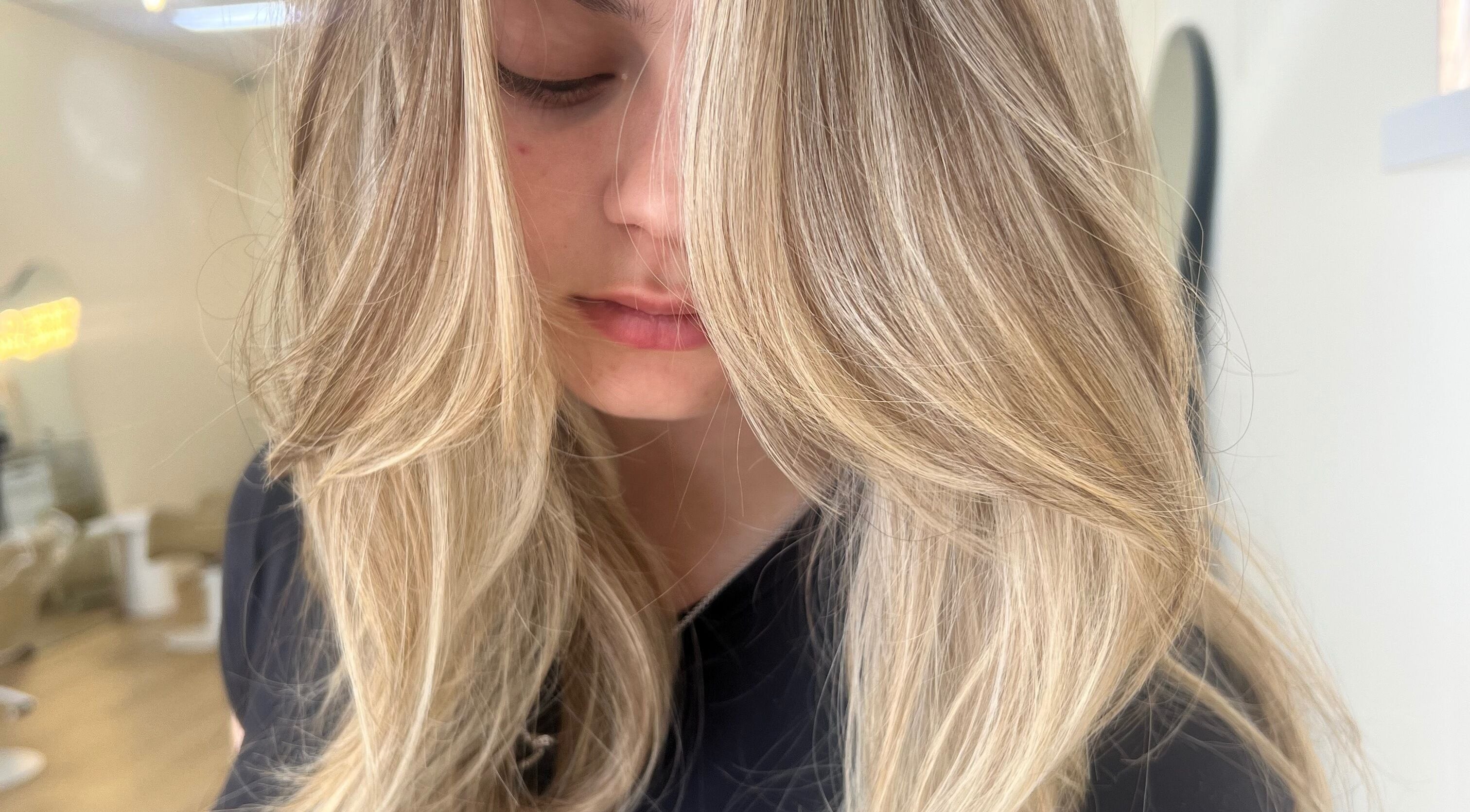 Close-up of sleek blonde hair at Valori Hair, Melbourne, Victoria, AU, showcasing expert styling.