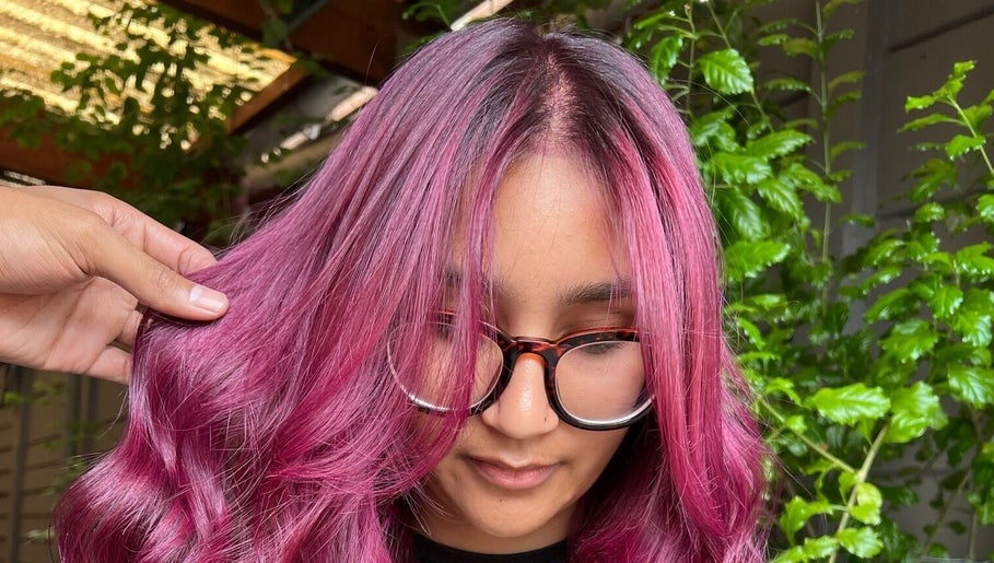 Close-up of vibrant magenta hairstyle at Cpt Hairn, Cape Town, Western Cape, ZA, highlighting modern salon techniques.