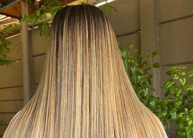 Glossy straight hair styled at Cpt Hairn in Cape Town, Western Cape, ZA with vibrant greenery background.