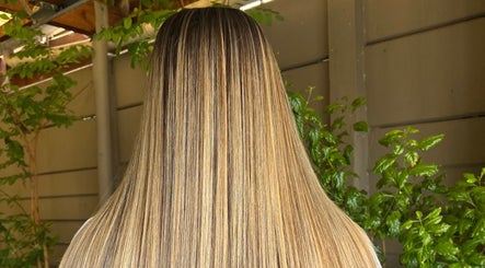 Glossy straight hair styled at Cpt Hairn in Cape Town, Western Cape, ZA with vibrant greenery background.