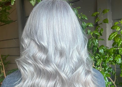 Elegant silver hair styled at Cpt Hairn, Cape Town, Western Cape, ZA, amidst lush greenery.