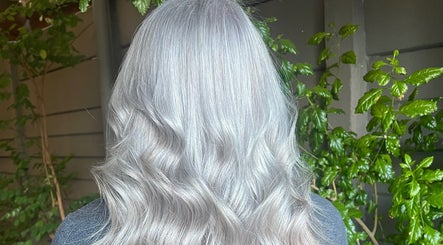 Elegant silver hair styled at Cpt Hairn, Cape Town, Western Cape, ZA, amidst lush greenery.