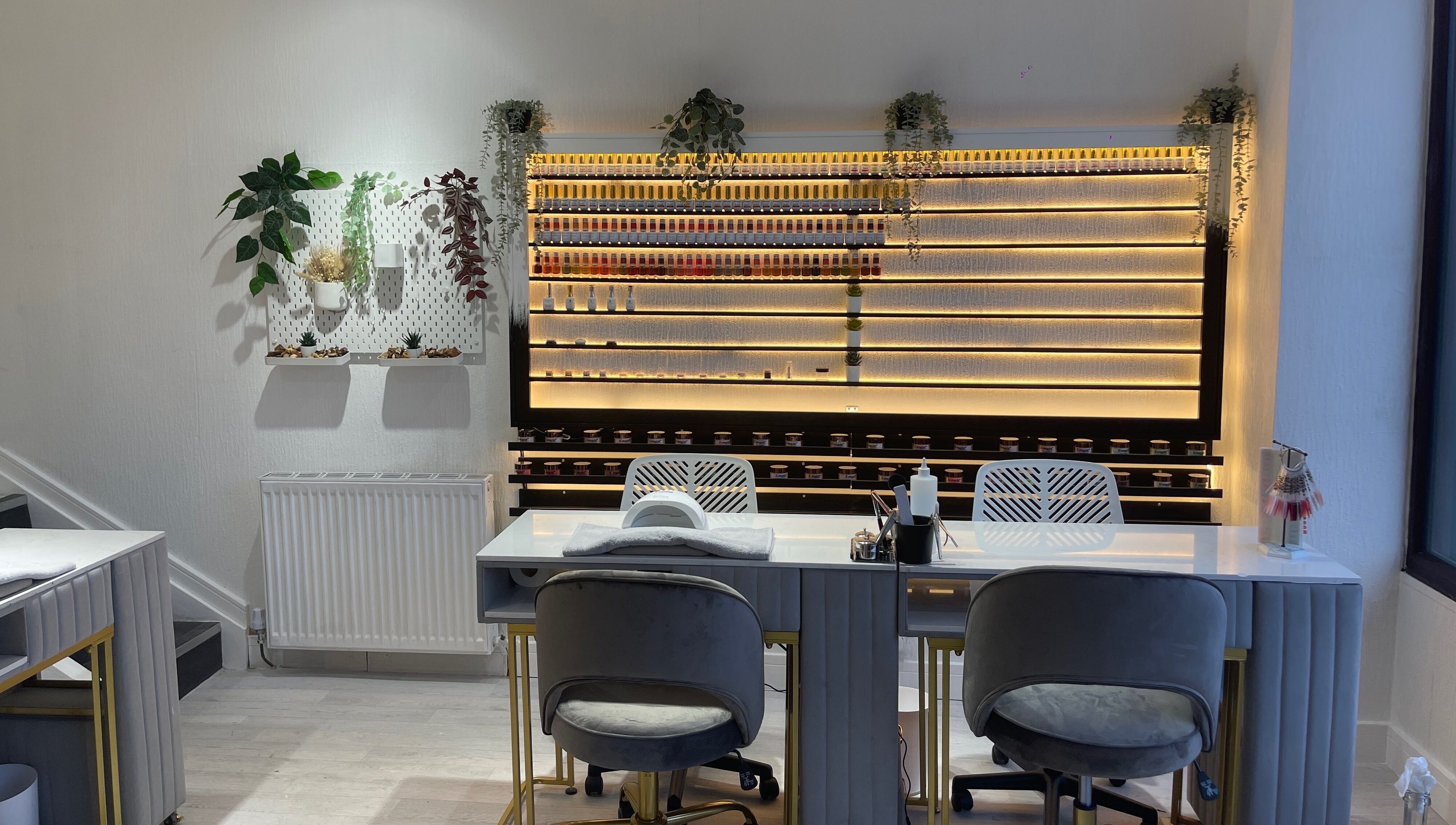 Sleek interior of Radcliffe Nails and Spa in Radcliffe, England, GB with nail polish display and seating.
