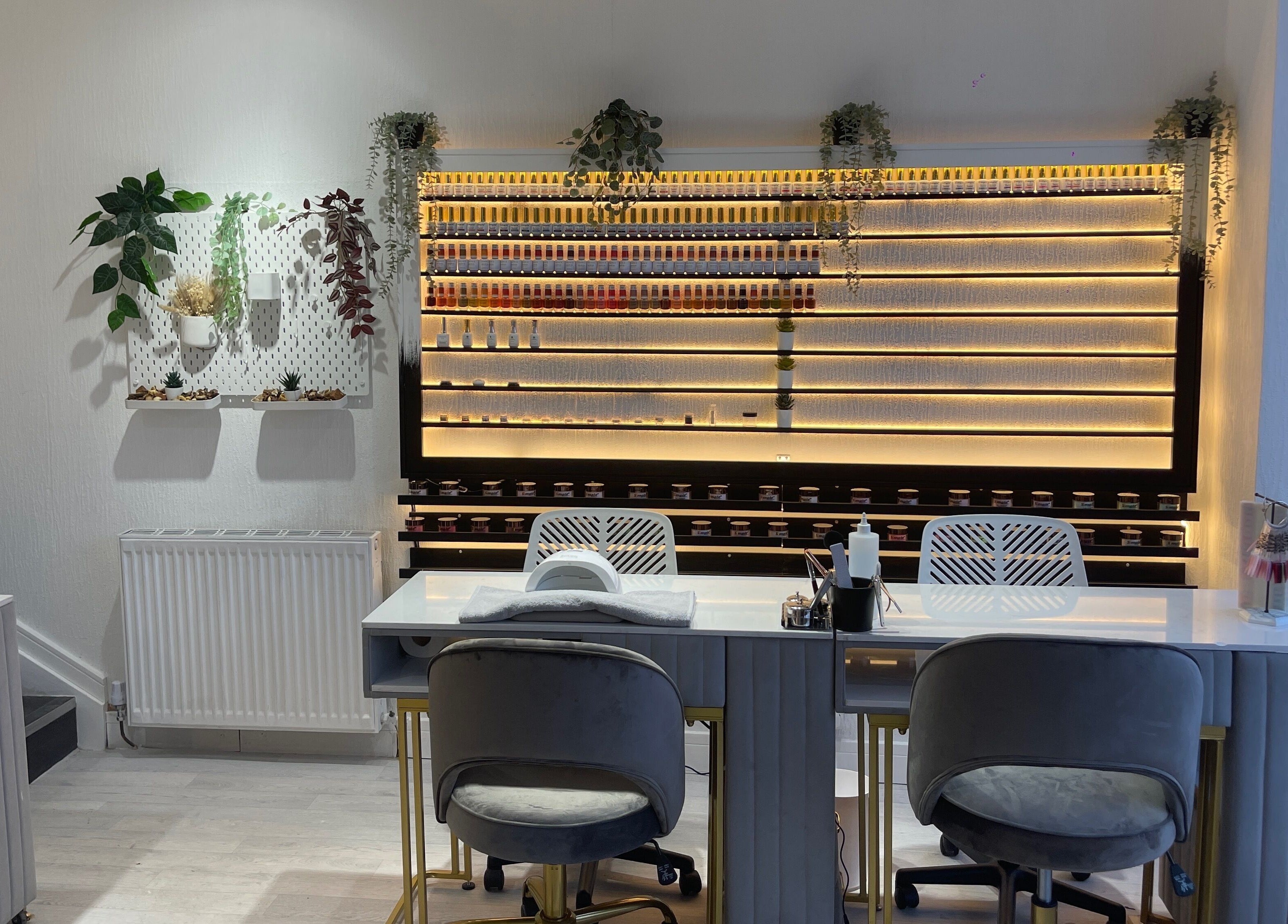 Sleek interior of Radcliffe Nails and Spa in Radcliffe, England, GB with nail polish display and seating.