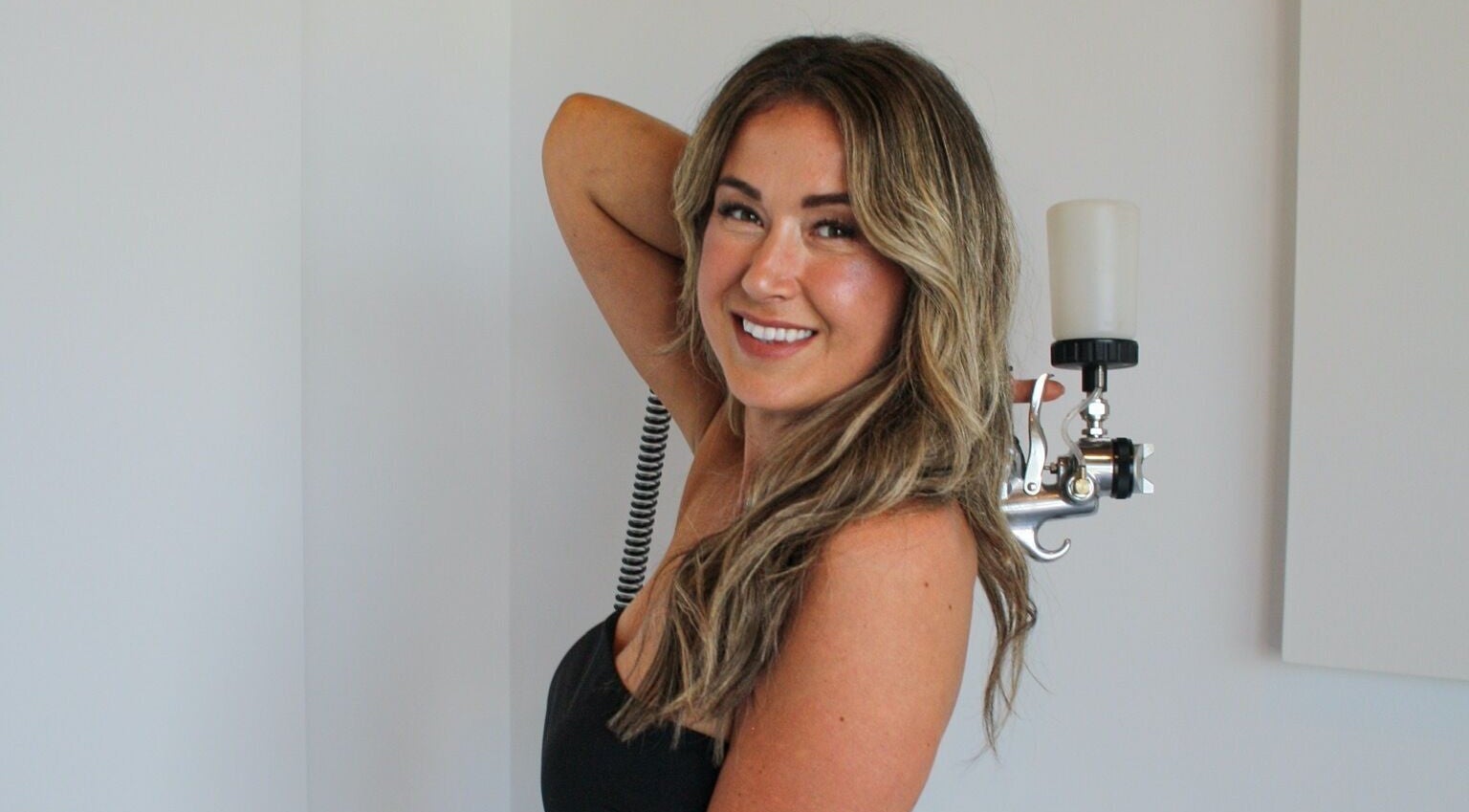 Airbrush tanning session at Afterglow Airbrush Studio, Nanaimo, British Columbia, CA with skilled technician.