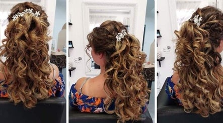 Gorgeous curled hairstyle at Carla Wernars Hairdressing in Alberton, Gauteng, ZA showcasing intricate floral accessory.