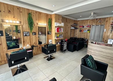 Interior of VIP Healthy Hair, Muang Pattaya, Chon Buri, featuring wooden decor and styling chairs.