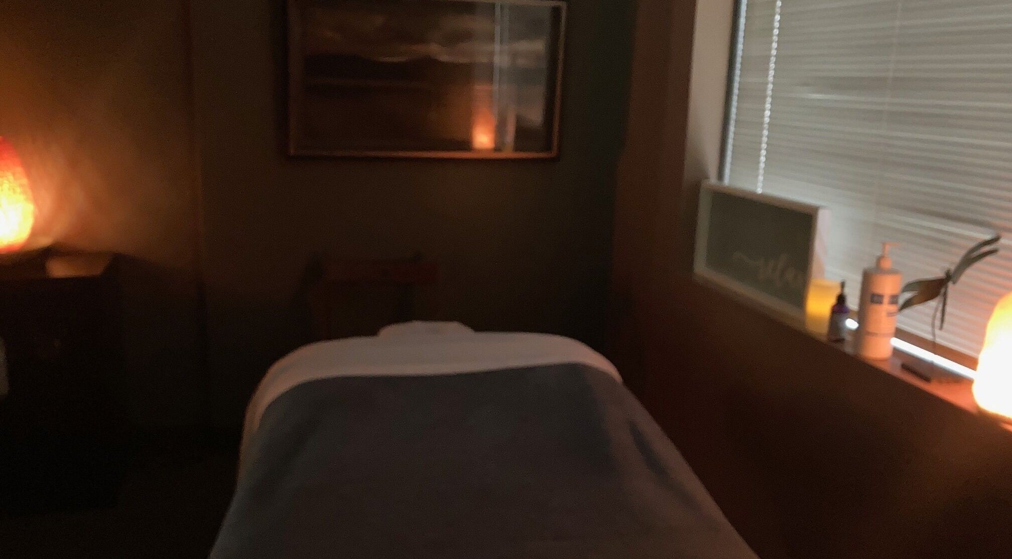 Tranquil massage room at Be Well Bodywork and Massage in Eagan, Minnesota, US with soft lighting.