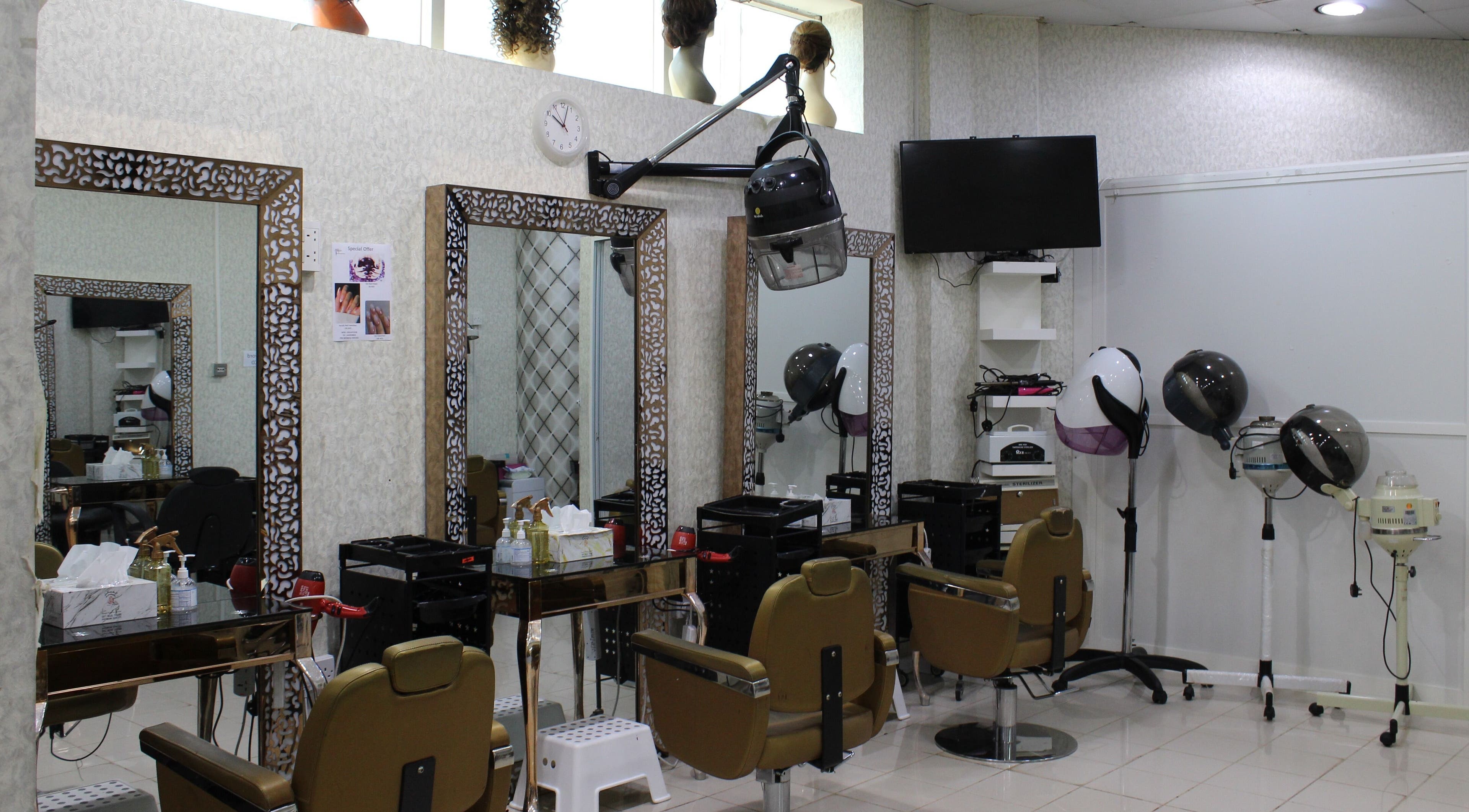 Chic styling stations at Urembo Ladies Salon, Dubai, Dubai, AE, featuring modern salon chairs and dryers.
