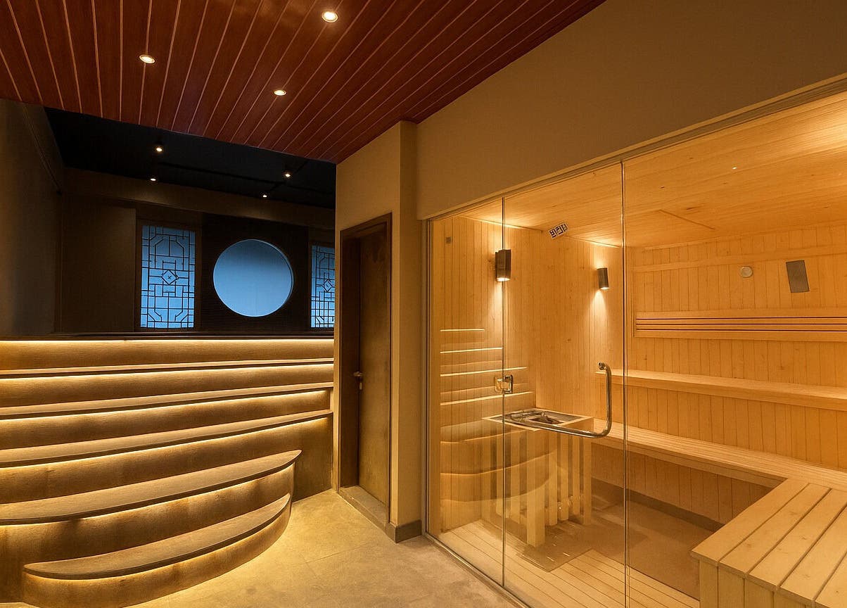 Luxurious sauna room at Grand Majesty Day Spa, Batam, ID with warm lighting and natural wood interiors.