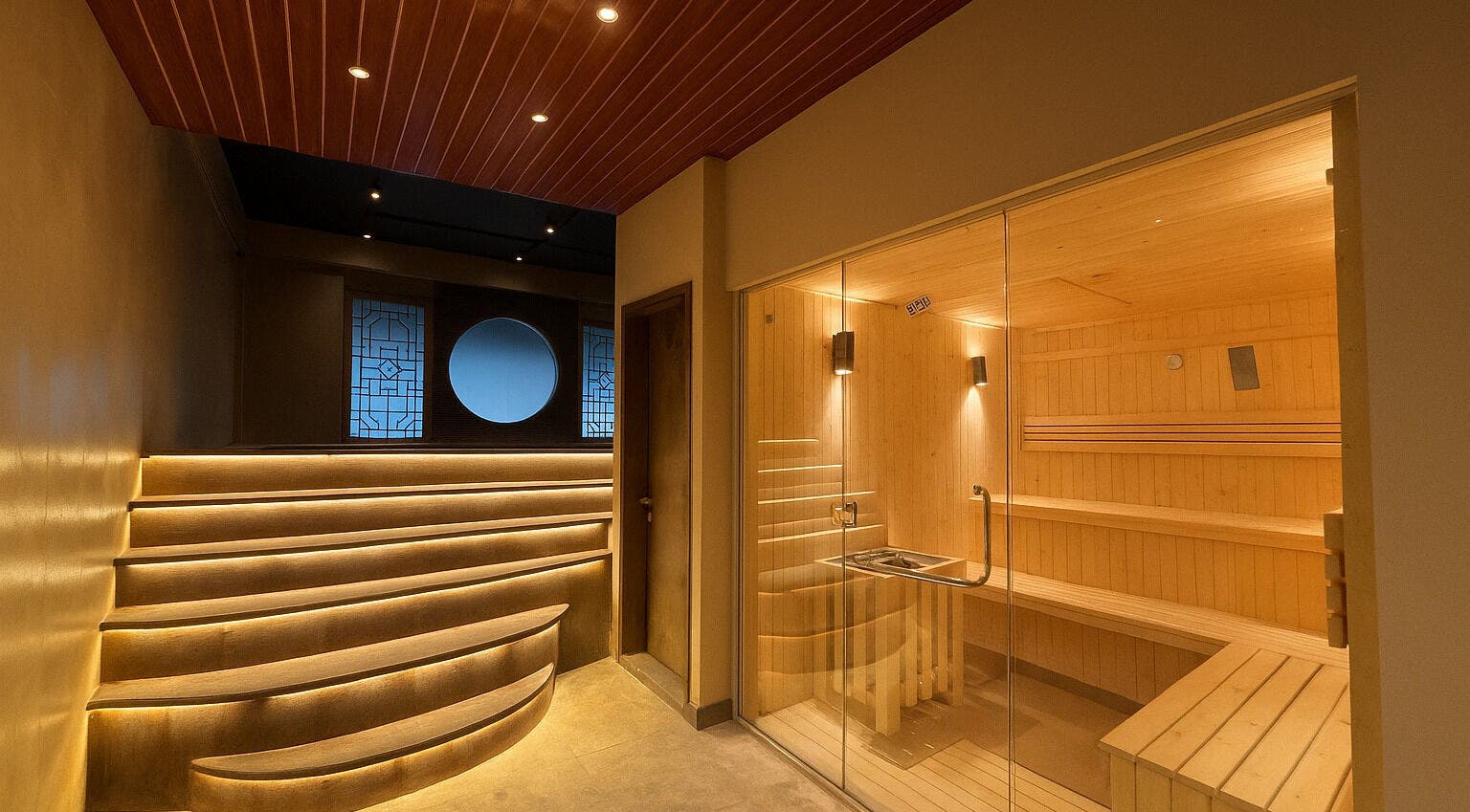 Luxurious sauna room at Grand Majesty Day Spa, Batam, ID with warm lighting and natural wood interiors.