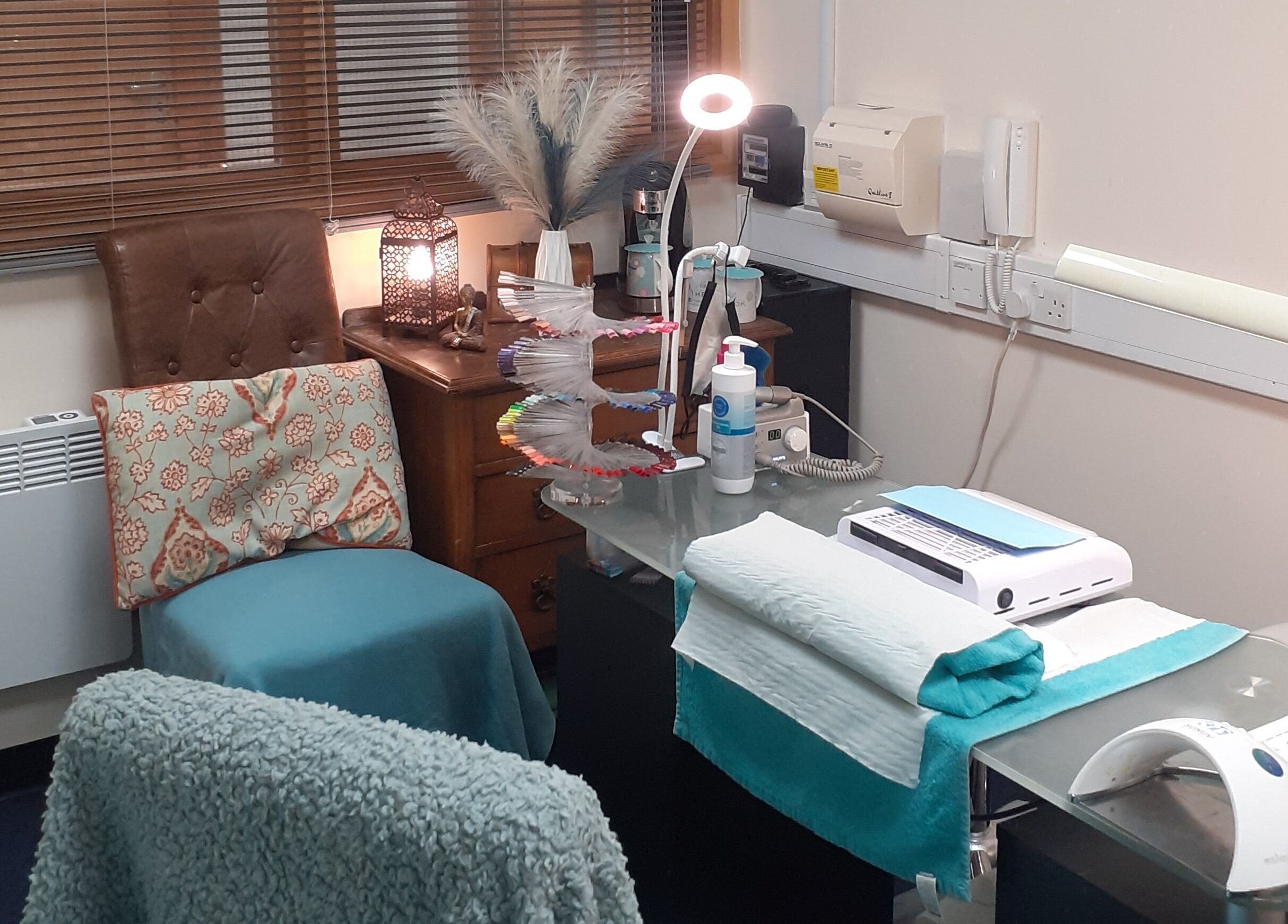 A cozy beauty treatment area at The Nook, Ellesmere Port, England, GB, featuring comfortable seating and nail care tools.