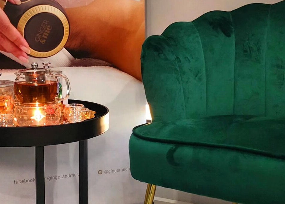 Cozy lounge at Beauty by Manola, Bayview, Northern Territory, AU with a green chair and tea set.